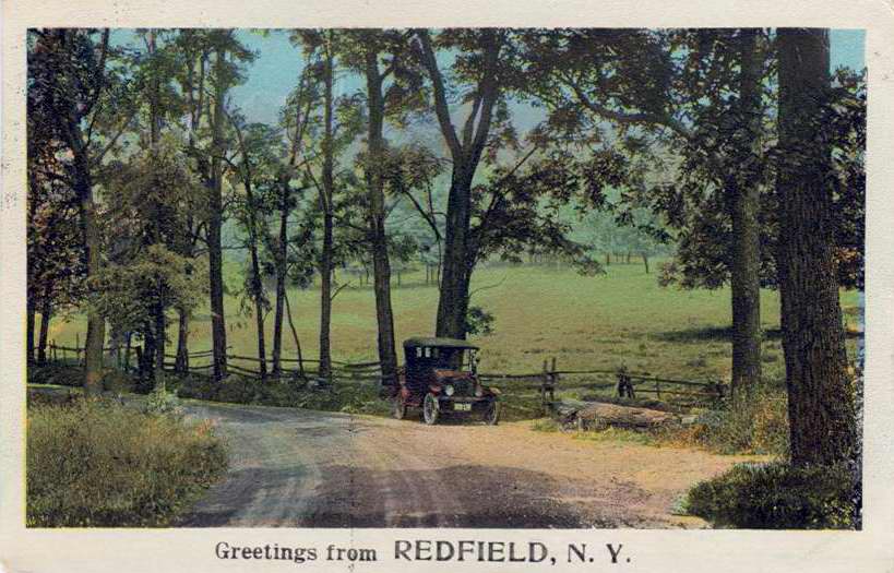 Color postcard with caption, "Greetings from Redfield, N.Y."  Rural scene with automobile.  Handwritten note on back.  Stamped with Redfield postmark. - Page 1