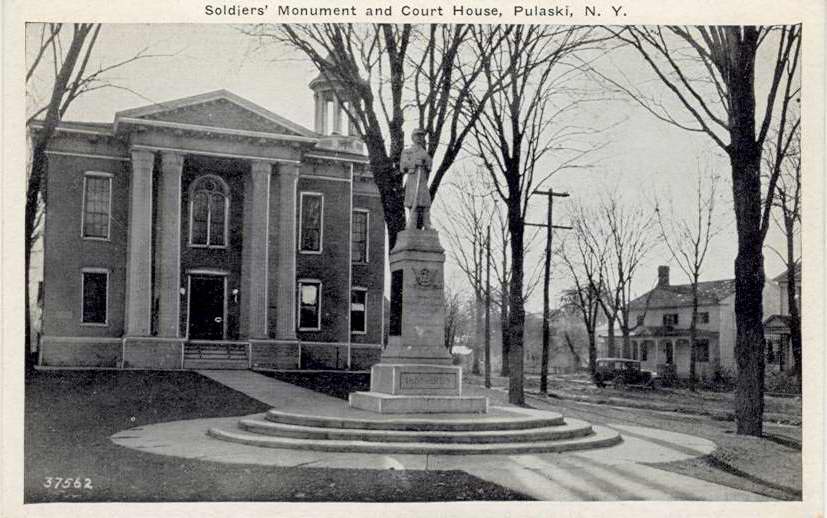 Black & white postcard with caption, "Soldiers' Monument and Court House, Pulaski, N.Y."  Handwritten note included, "Monument was built after World War I.  B. G. Seamans, Ch. Committee.  Mary Parker, Historian, Pulaski, 1983". - Page 1