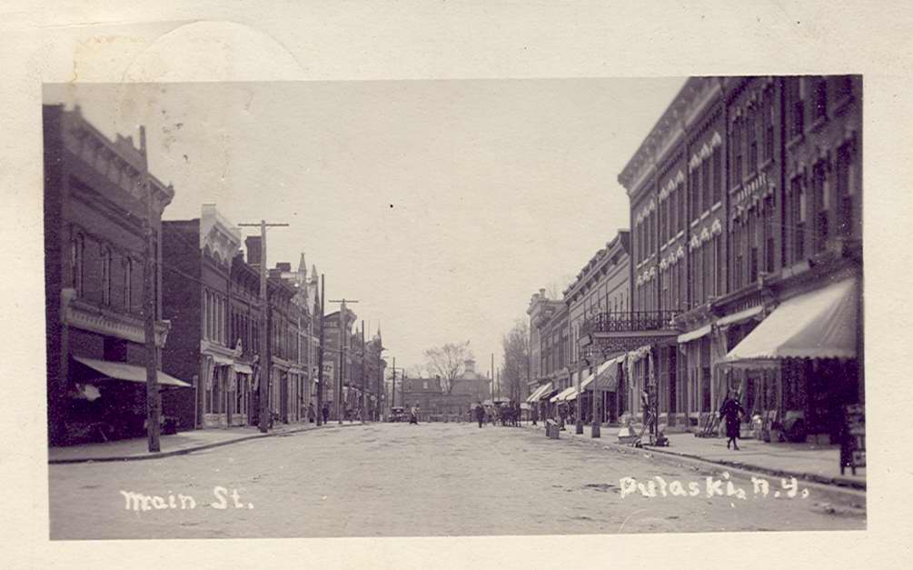 Black & white postcard with caption, "Main St., Pulaski, N.Y."  Handwritten message on back.  Stamped with Pulaski postmark. - Page 1