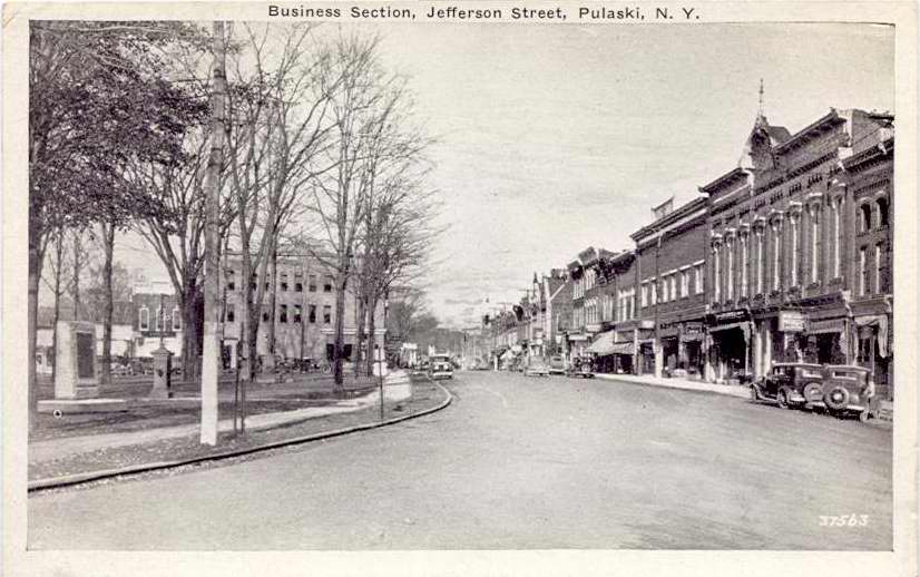Black & white postcard with caption, "Business Section, Jefferson Street, Pulaski, N.Y." - Page 1