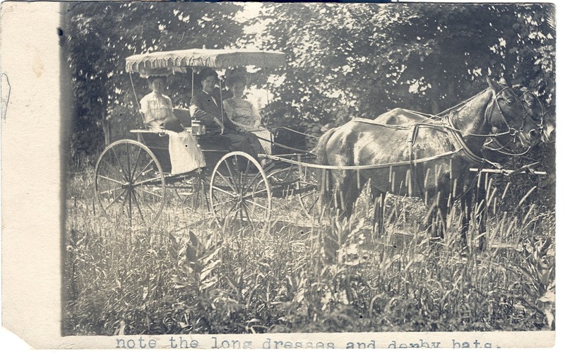 Horse and carriage with unidentified persons.  Two horses pull a befringed covered carriage in a rural scene.  Two women and a man sit inside. - Page 1